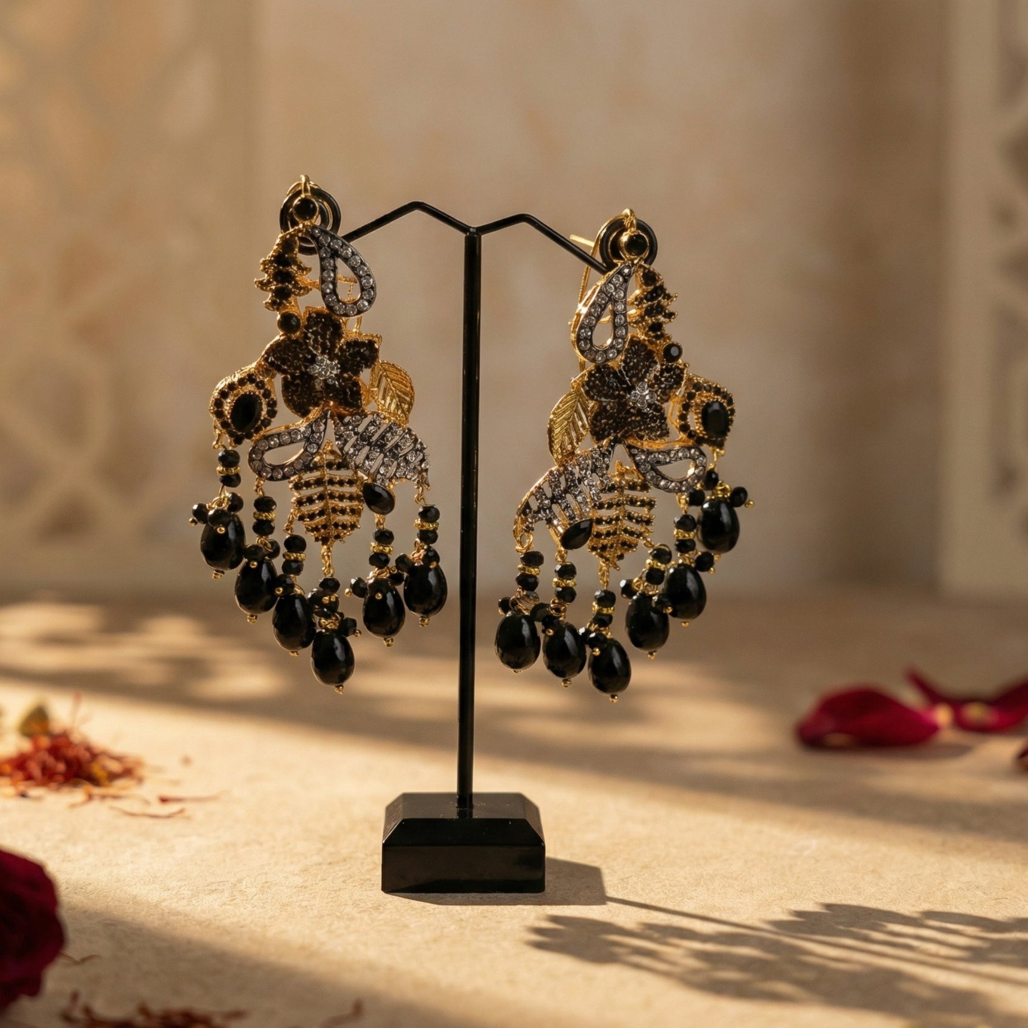 Ornate earrings on a stand with a decorative background