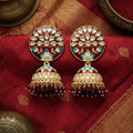 Ornate earrings on a red fabric background