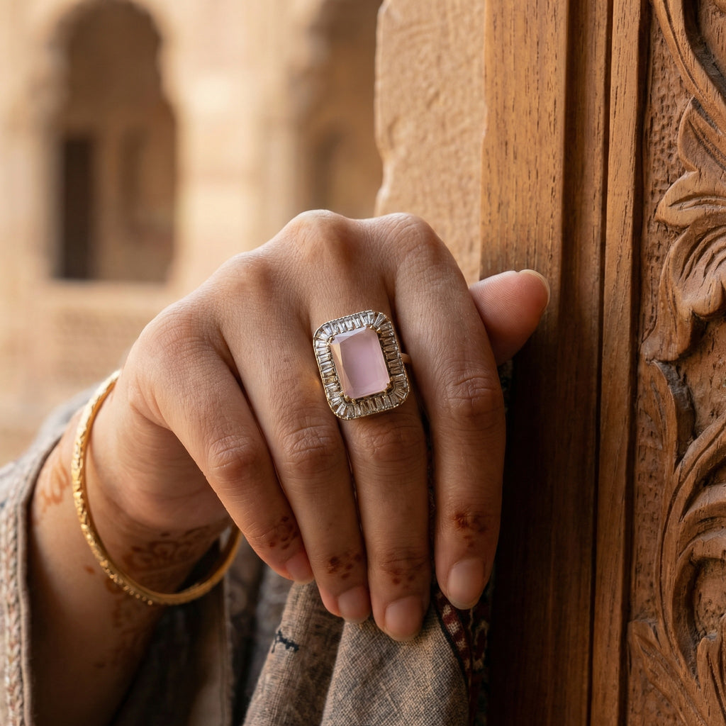 Hand with a pink ring on a wooden door with intricate carvings